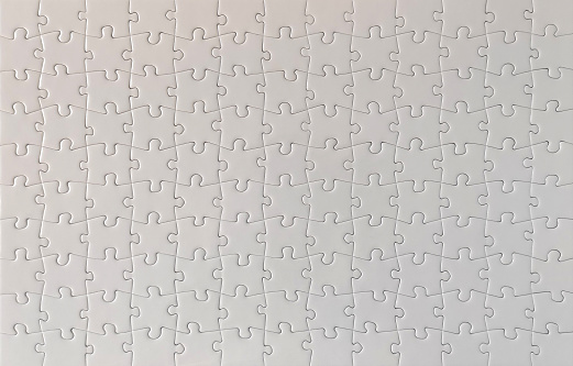 Close-up of blank white jigsaw puzzle texture background