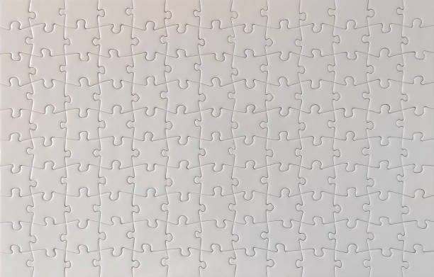 Close-up of blank white jigsaw puzzle texture background stock photo
