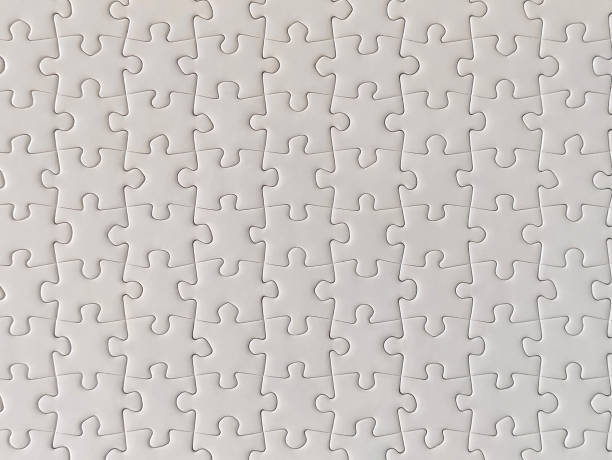 istock Close-up of blank white jigsaw puzzle texture background 1299947025