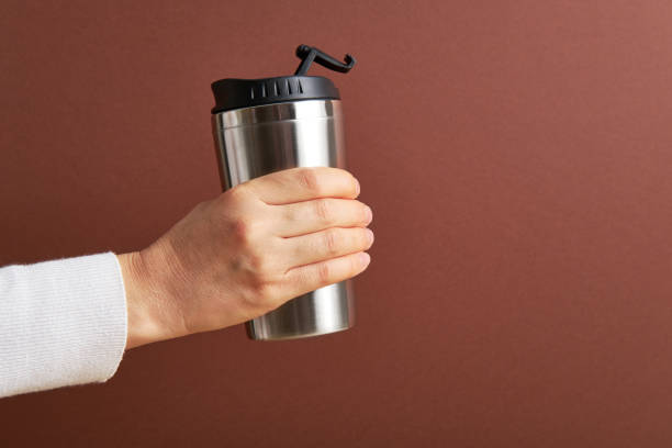 istock Woman holding reusable coffee cup 1299948060