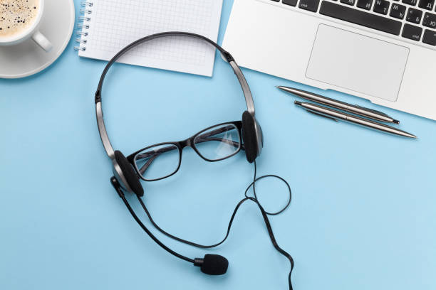 istock Office desk with headset and laptop. Work from home 1299948092