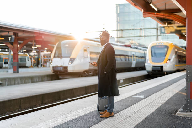 istock Businessman with face mask waiting for the train 1299948498