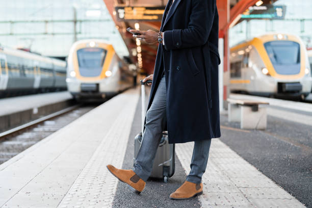 istock Businessman waiting at the train station 1299948520