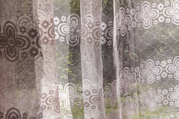 istock Curtain made of white tulle with patterns 1299951573