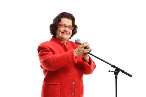 istock Elderly woman with a microphone smiling at the camera 1299952814