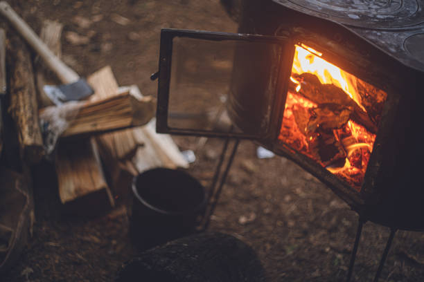 Wood stove fires. Winter camping in the woods. stock photo