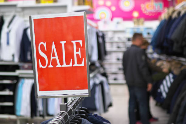 istock Sale notice in a clothes store. 1299952894