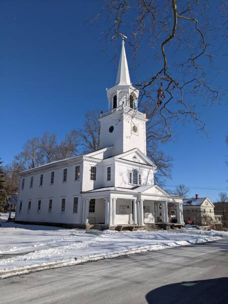 istock Church on a snow covered town green 1299954508