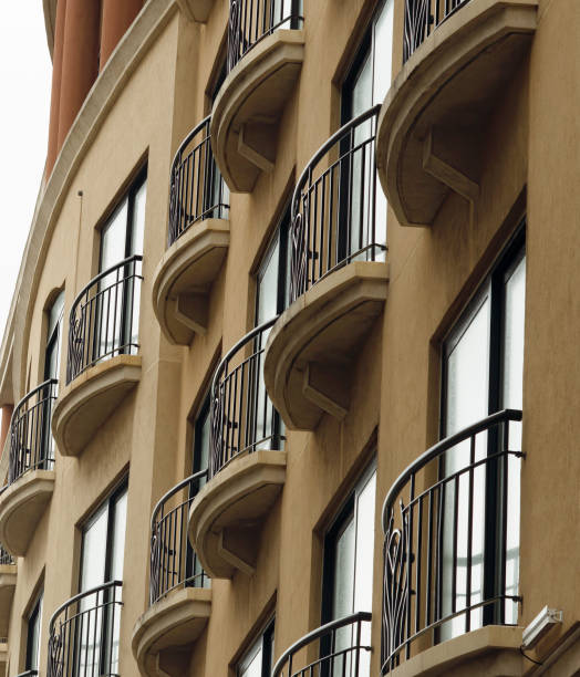 istock Building Facade With Tall Windows And Wrought Iron Railing Balconies 1299955303