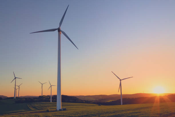 istock wind turbines on field at sunset 1299957415