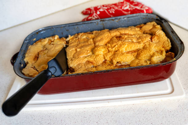 istock Baked apple dessert in pan on kitchen table. 1299958530