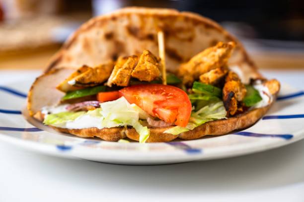 istock Roasted chicken pieces in pita bread with vegetable salad - shawarma. 1299958577