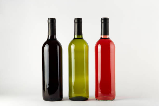 Empty bottles and a wheel standing on a wall on blue sky