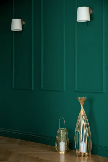 istock Stylish emerald green wall with molding 1299959975
