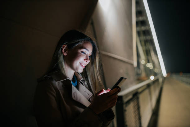 istock A young woman using her cellphone while out in the city 1299962942