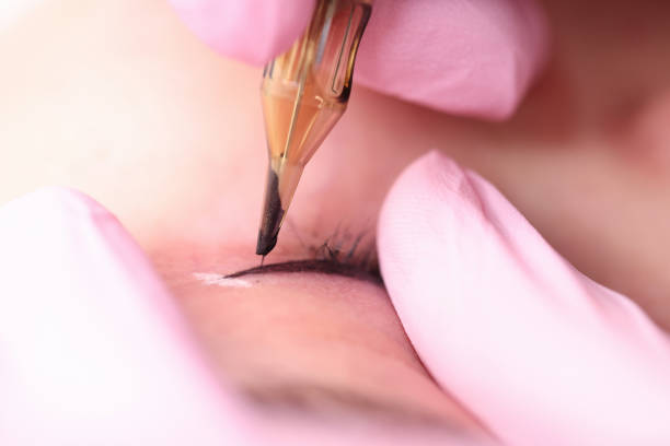 istock Beautician making black arrows in front of female client closeup 1299963663