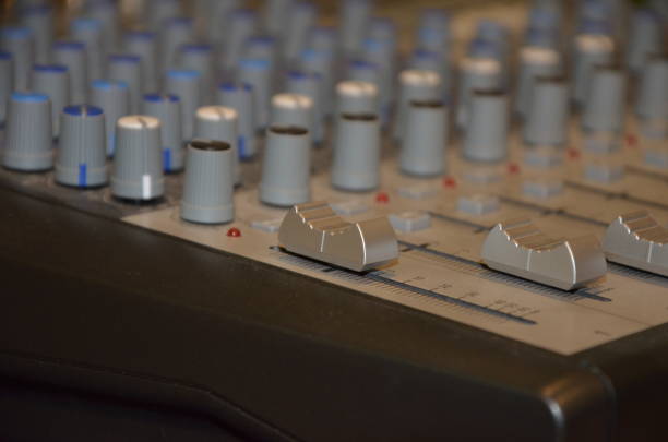 istock Professional audio mixing console with faders and adjusting knobs. TV, radio and sound equipment selective focus 1299963706
