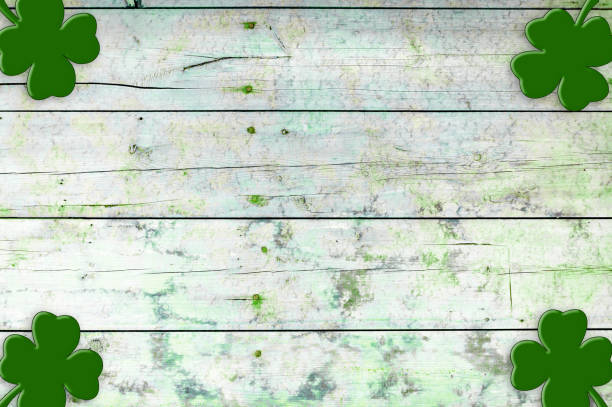 istock St Patricks day background. Shamrocks over a light green wood background. 1299964718