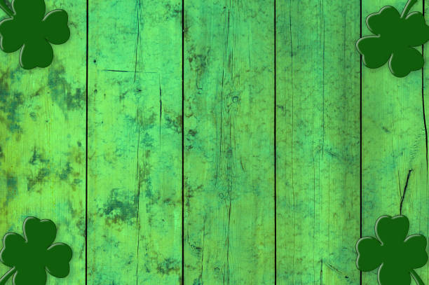 istock St Patricks day background. Shamrocks over a light green wood background. 1299964847