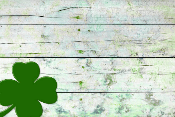 istock St Patricks day background. Shamrocks over a light green wood background. 1299964850