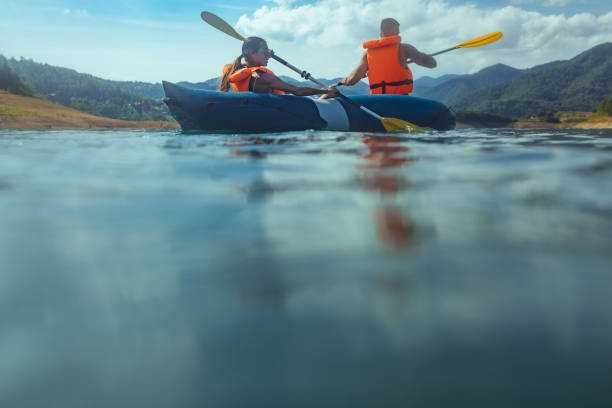 istock Lovely young couple on a kayak rowing 1299966534