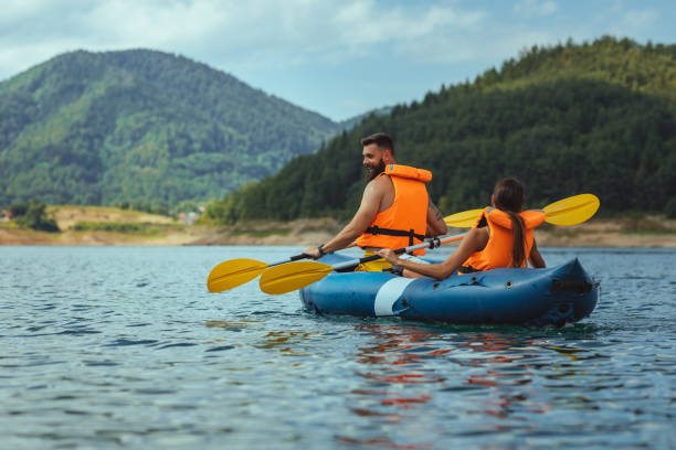 istock Paddling young couple on the river 1299967190