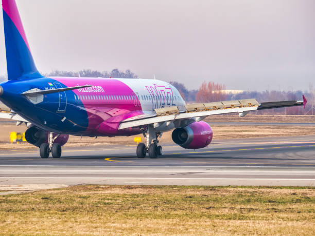 a wizz air airbus a320-232 (ha-lwn) airplane on the airport runway at henri coanda international airport. - wheel airplane landing air vehicle imagens e fotografias de stock