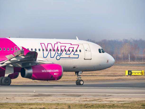 a wizz air airbus a320-232 (ha-lwn) airplane on the airport runway at henri coanda international airport. - wheel airplane landing air vehicle imagens e fotografias de stock