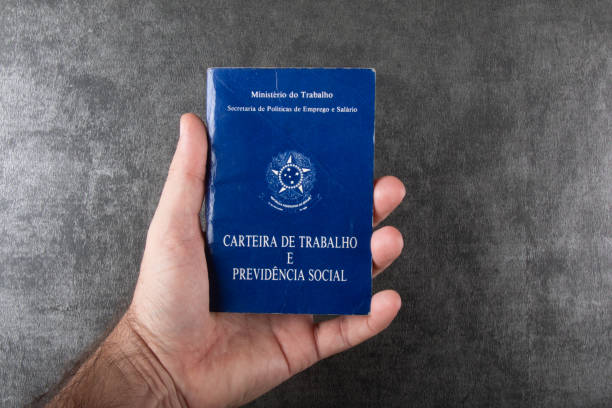 istock Hand holding Brazilian work card isolated top view space copy 1299968821