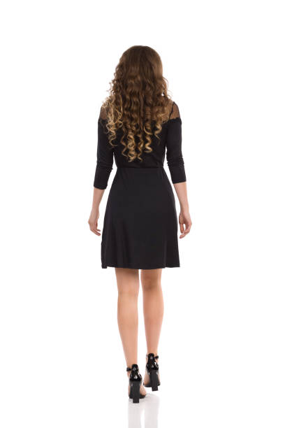 istock Elegant Young Woman Takes A Step. Rear View. 1299969192