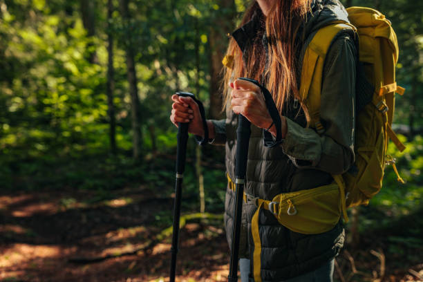 istock Young female holding hiking poles 1299969276