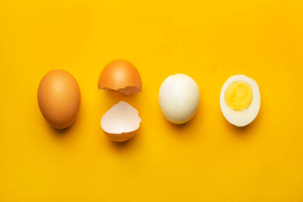 istock Fresh brown chicken boiled egg on yellow background 1299969316