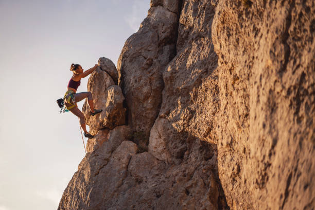 Young female climber on the rock mountain