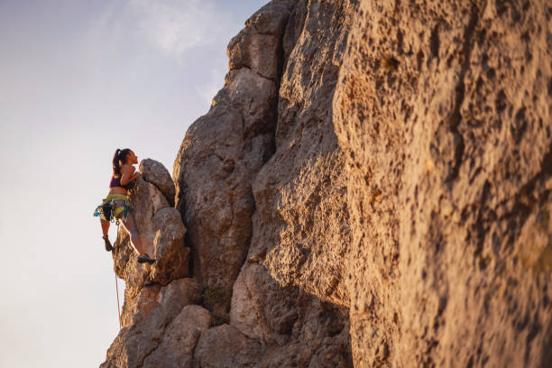 istock Young female climber is approaching her goal 1299970354