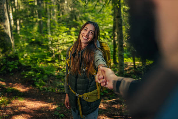 istock Smiling couple holding hands in the forest 1299970540