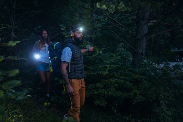 istock Young couple going through the woods at night 1299970943