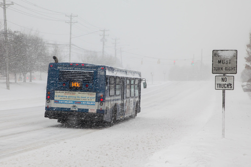 Norwalk, CT, USA-February 1, 2021:   CT Transit transportation bus  during snow storm  day on Connecticut Ave.
