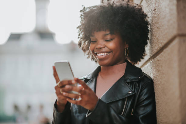 istock A young afro woman using her phone outside 1299972045