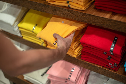 Person choosing fashion colorful t-shirt