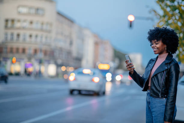 istock Young black woman using phone and while out in the city 1299972849
