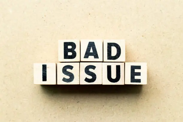 Photo of Letter block in word bad issue on wood background