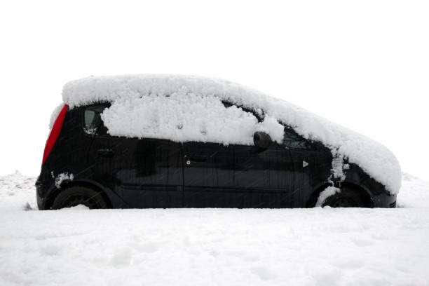 istock Car under thick blanket of snow after storm isolated on white background. 1299974710