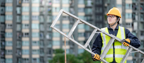 istock Maintenance worker man carrying aluminium ladder 1299974785