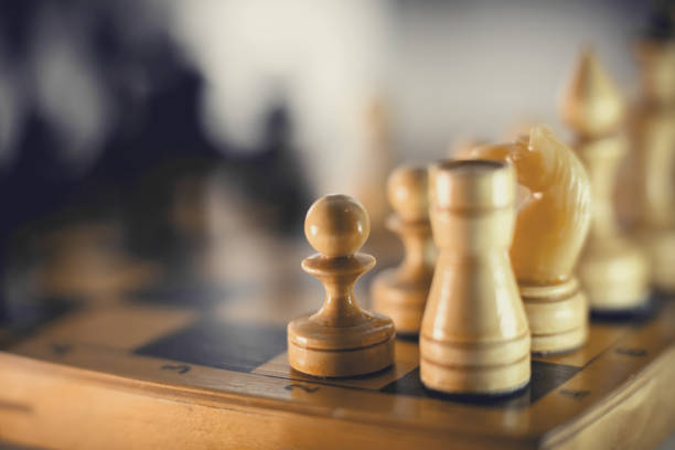 istock Wooden chess pieces on the chessboard. 1299974892