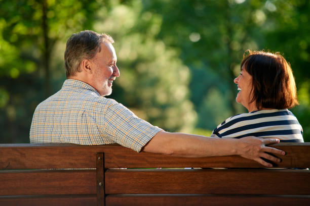 istock Happy laughing couple on the bench. 1299975834
