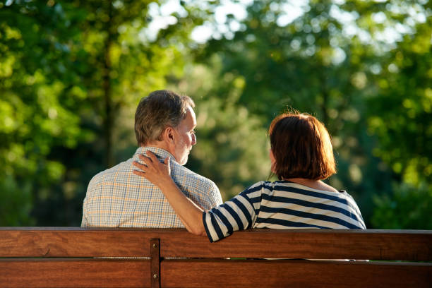 istock Back view retired senior couple on the bench. 1299976184