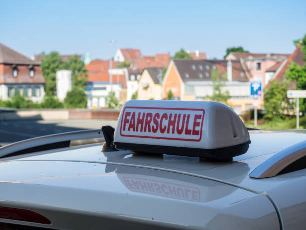istock Driving School Sign On Car in german 1299976999