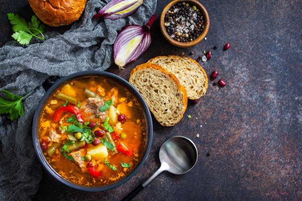 istock Homemade Meat Tomato soup with beef and bean stew, vegetables on a stone tabletop. Top view flat lay. Copy space. 1299977023