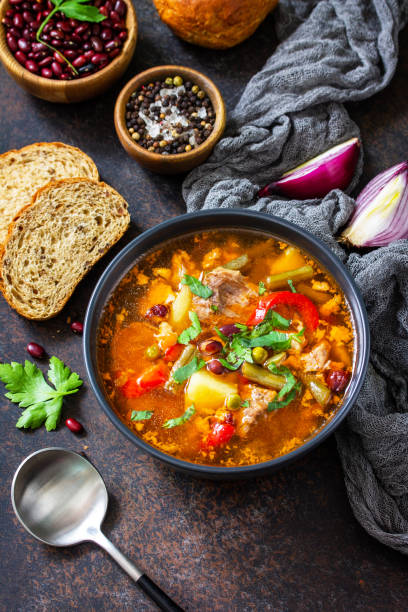 istock Homemade Meat Tomato soup with beef and bean stew, vegetables on a stone tabletop. Copy space. 1299977032