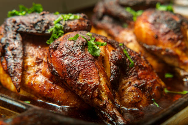Cooking Peruvian Halved Chicken Cooking pan Peruvian roasted half chicken pollo a la brasa peruvian culture photos stock pictures, royalty-free photos & images